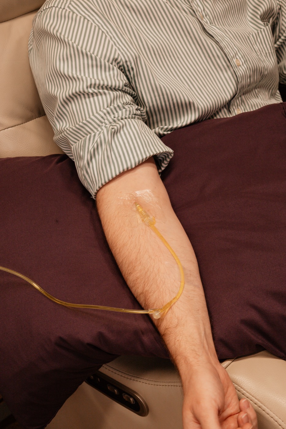 An IV line in a patient's arm during a vitamin drip
