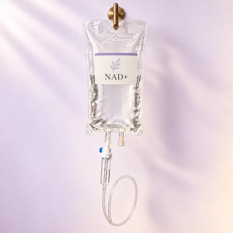 A NAD+ IV bag hanging from a brass hook