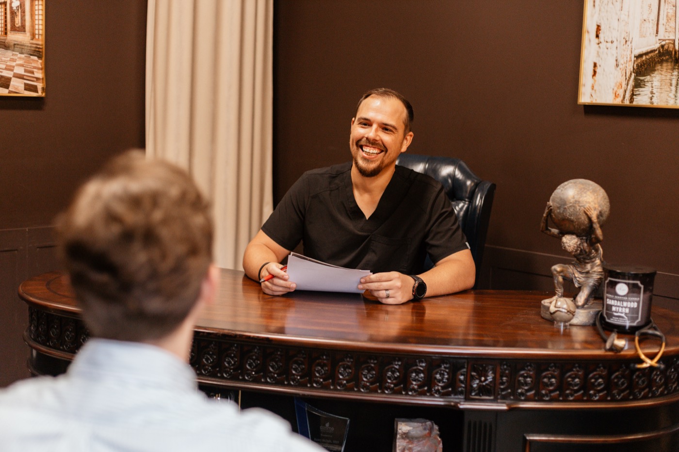Dr. Kasey Nichols at his desk going over results with a patient