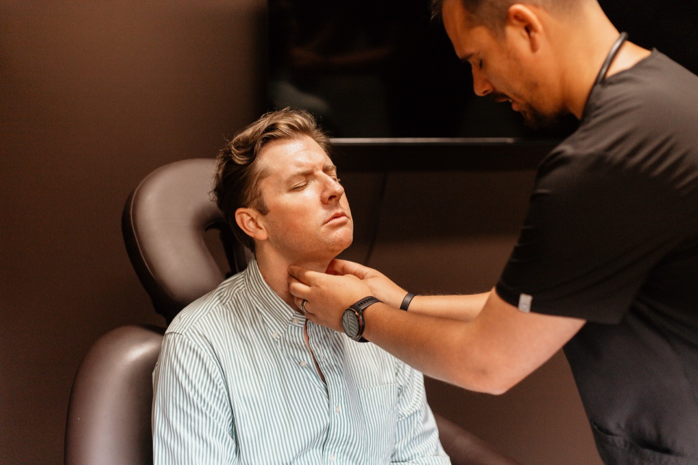 Dr. Kasey Nichols examining a patient's thyroid