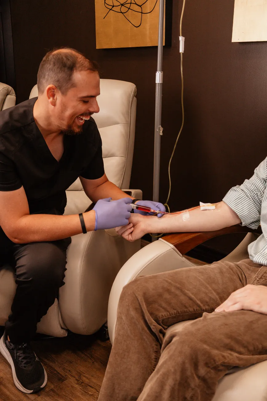 Dr. Kasey Nichols drawing blood from a patient in the Onyx IV lounge